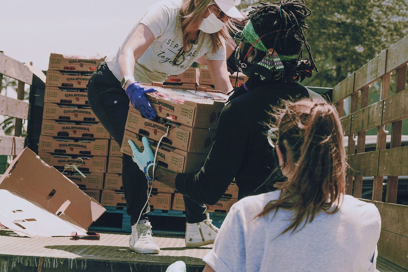 Volunteers emptying goods from the back of a truck